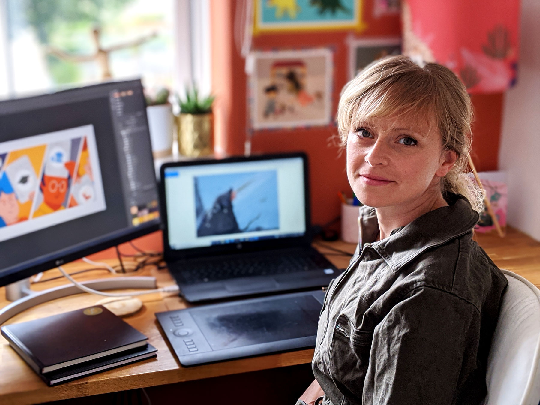 Lucy de Burgh sitting at her desk